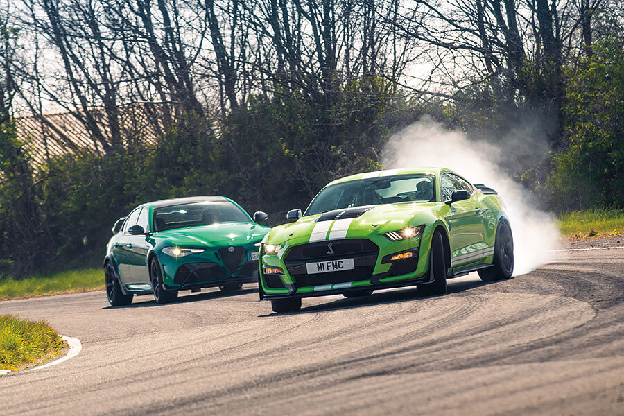 愛快Giulia GTAm與福特Mustang GT500狹路相逢。問世間當真有人需要這麼狂妄的殺傷力嗎?一起塞進耳塞查明真相吧!